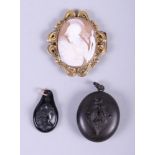 A 19th century gilt metal mounted cameo of Athena, a vulcanite mourning locket with lily of the