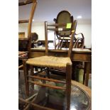 A child's late 19th century spindle back rush seat side chair, on turned and stretchered supports