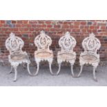 A set of four 19th century cast iron garden chairs with circular seats, on shaped supports