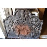 A cast iron fireback with lion, thistle, Tudor rose and fleur-de-lis design, dated 1614, and a