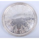 A Georgian silver salver with engraved decoration and gadrooned border, on three winged putti