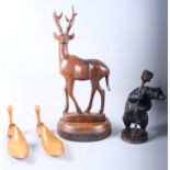 A Continental carved wood bear candlestick, 11 1/2" high, a hardwood model of a deer and a pair of