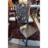 A 19th century carved oak hall chair with panel seat