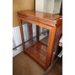 A Chinese hardwood and glass display cabinet with lighting, on shaped square supports, 49" high