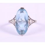 An 18ct white gold and aquamarine Art Deco ring, central oval stone flanked diamonds, ring size M