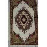 A rug with central medallion on a natural ground, 64" x 37" approx