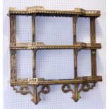 A 19th century Gothic gilt framed three-tier open fret work wall shelf, 28" wide