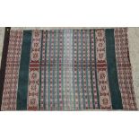 An antique Ikat panel with geometric bands and figures, 61" x 40", with hardwood batten