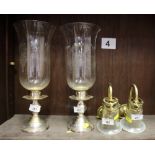 A pair of silver plate and etched glass storm lanterns, 14" high, a pair of brass and glass wall