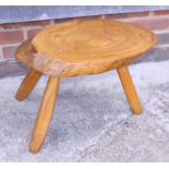 A rustic oak tree trunk stool, on three splay supports, and a teak occasional table, on tripod