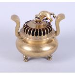 A Chinese brass two-handled censer, the pierced lid with Kylin surmount, on dragon mask feet, 7"