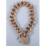 A 9ct gold heavy curb link bracelet with heart-shaped clasp, 26.4g