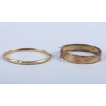 A 9ct gold bangle with engraved floral decoration and another 9ct gold bangle, 27.1g