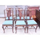 A set of six walnut standard dining chairs of Queen Anne design with drop-in seats, on cabriole