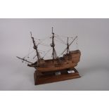 An early 20th century wooden scale model of the Mayflower, 15" long overall, on rectangular plinth