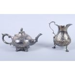 A Victorian silver cream jug with embossed floral sprays, on pad feet, 6oz troy approx, and a silver