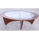 A mid 20th century Ercol mahogany and glass inset oval coffee table, on stylised supports, 48" wide