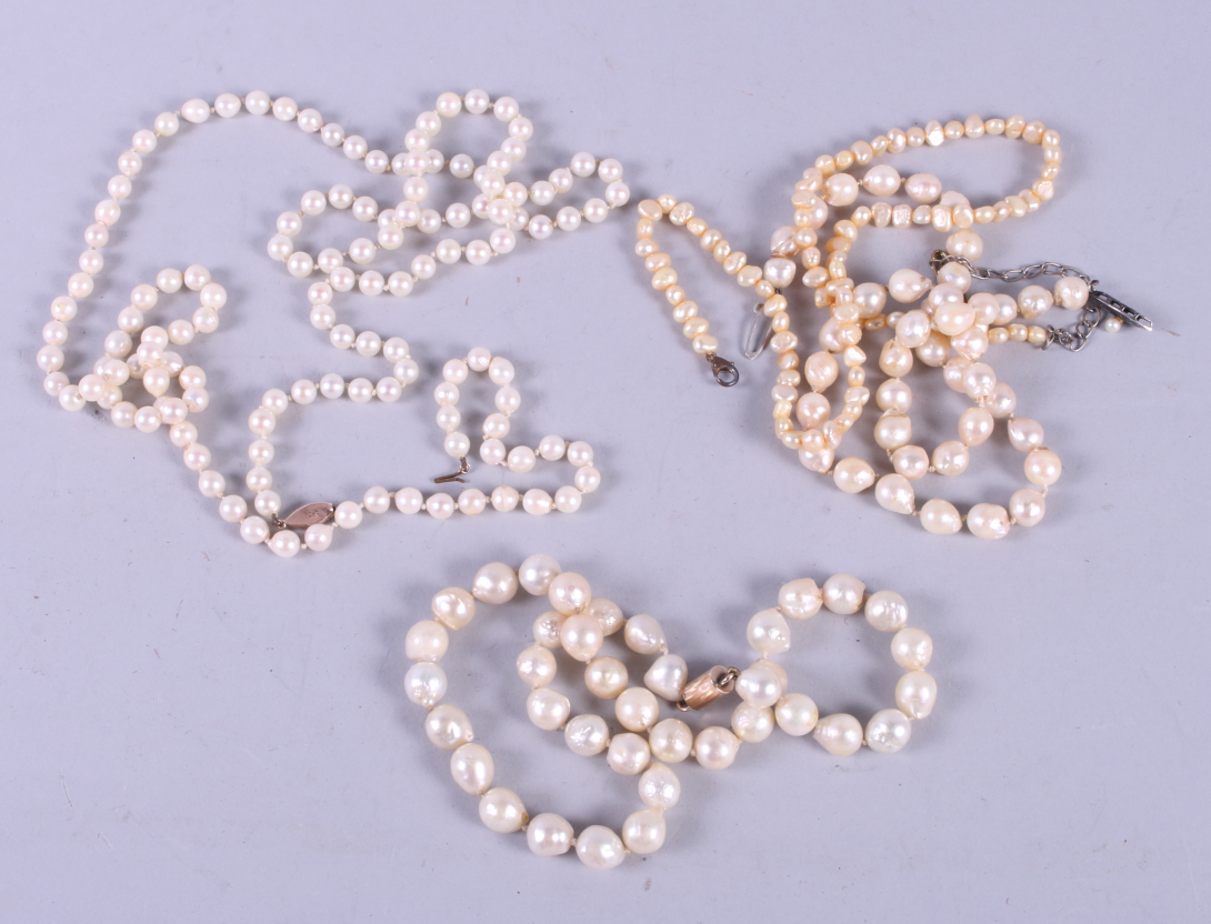 A Baroque pearl necklace with gold clasp and three other pearl necklaces