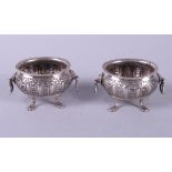 A pair of 19th century Dutch silver salts with embossed decoration and lion mask handles, 2.9oz troy