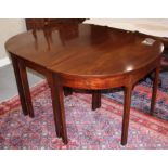 An early 19th century mahogany 'D' end dining table with centre section and two extra leaves, on