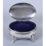 An oval silver ring box, on four supports, and a silver mesh evening purse with fabric lining