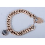 A 9ct rose gold curb link bracelet with 9ct gold padlock clasp