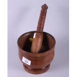 An antique treen mortar and a companion boxwood pestle, mortar 6" dia