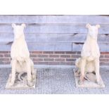 A pair of cast stone models of seated greyhounds, 37" high (both a/f)