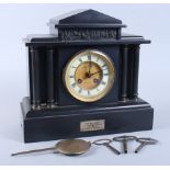 A 19th century slate mantel clock with flanking columns, eight-day striking movement by Goulding and