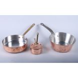 Three copper saucepans and a cover