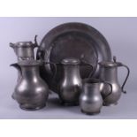 A pewter charger, three pewter jugs, etc