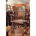 A spindle back rocking chair with panel seat