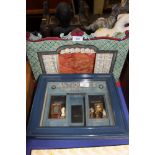 A French framed miniature three-dimensional model of an antique shop and a hand-painted model