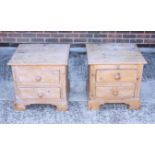 A pair of waxed pine bedside chests of two drawers, on turned supports, 21" wide