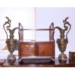 A pair of late Victorian brass ewers, cast with classical figure decoration, on circular bases,