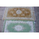 An Indian wool rug on a green ground, 56" x 28" approx, and a similar rug on a sand ground, 52" x