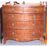 An early 19th century mahogany bowfront chest of two short and three long graduated drawers with