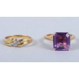 An 18ct gold diamond four stone ring, and an 18ct gold ring set single synthetic corundum