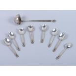 A set of eight Georg Jensen teaspoons and a matching twin lipped ladle of the "Acorn" design by