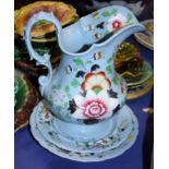 A 19th century Ridgeway pottery jug, bowl and plate with floral decoration on a blue ground