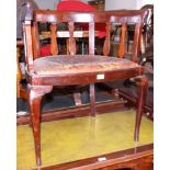 An early Edwardian mahogany splat back chair, with leather drop-in seat, on splay supports