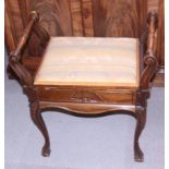 An early 20th century carved walnut box seat piano stool, on cabriole supports