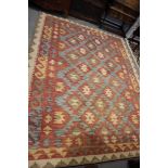 A woollen carpet of traditional kelim design, supplied by OKA, 120" x 90" approx