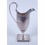 A George III silver helmet cream jug, London 1799, on square base, 6 1/4" high (loaded)