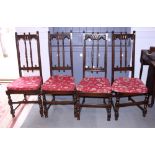 A set of four Ercol polish high back chairs of 17th century design with seat cushions