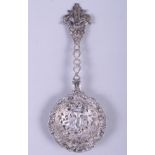 A 19th century Dutch silver loving spoon, with pierced bowl decorated cherub in a foliate landscape,