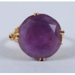 A 14ct gold ring, set synthetic corundum, shoulders formed as a flower, ring size N/O