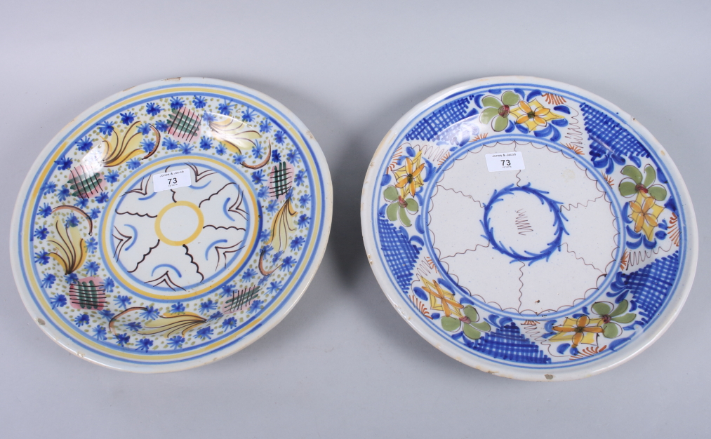 Two 19th century French faience pottery plates with brightly coloured floral decoration, 12 1/2"