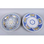 Two 19th century French faience pottery plates with brightly coloured floral decoration, 12 1/2"