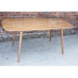 A late 20th century blonde Ercol table, on square supports